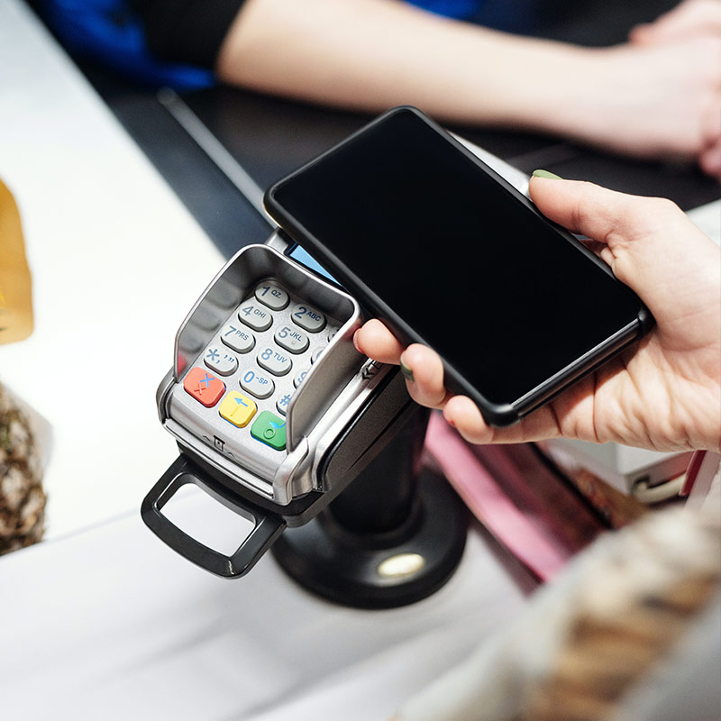 Person tapping their phone as payment.
